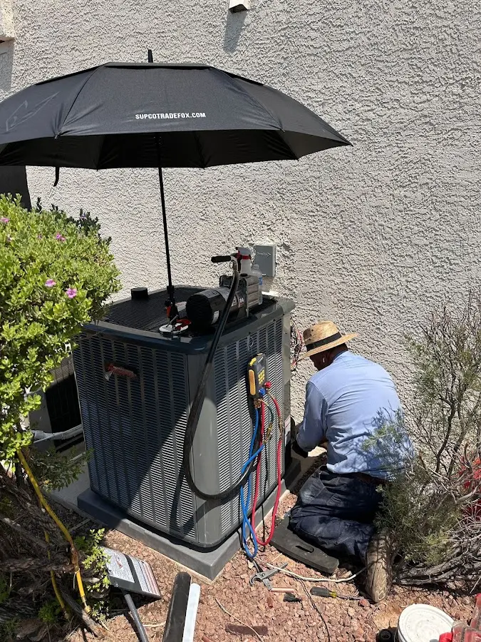 HVAC technician performing outdoor AC maintenance in Milpitas